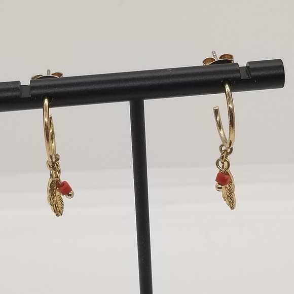 gold tone hoop earrings with feather charm and red bead - Picture 2 of 3